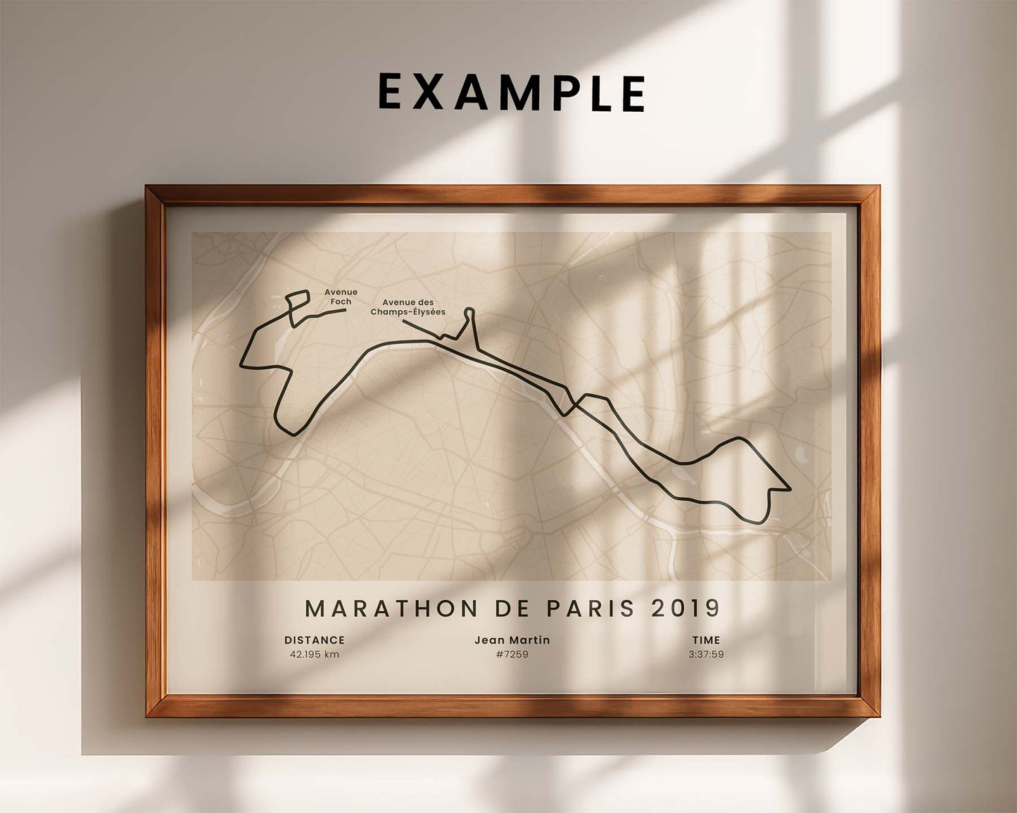Framed custom marathon poster of the route for Marathon de Paris 2019 on a wall with sunlight casting shadows.